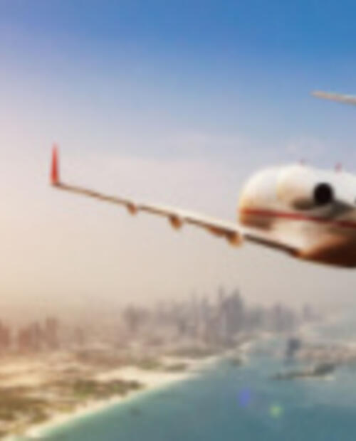 business jet flying into a city